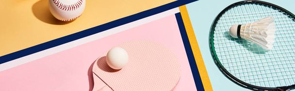 Badminton and table tennis kits with baseball ball on colorful background with lines, panoramic shot - 写真・画像