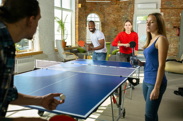 Young people playing table tennis in workplace, having fun - Photo, image