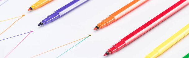 panoramic shot of colorful felt-tip pens on white background with connected drawn lines, connection and communication concept - 写真・画像