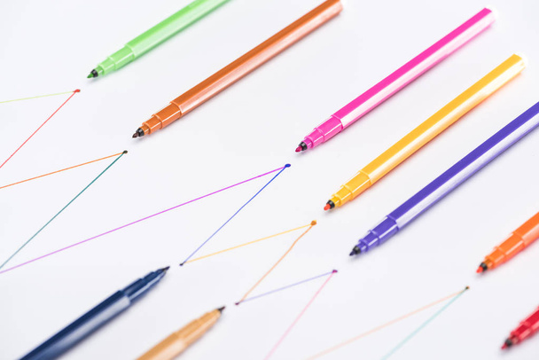 colorful felt-tip pens on white background with connected drawn lines, connection and communication concept - 写真・画像