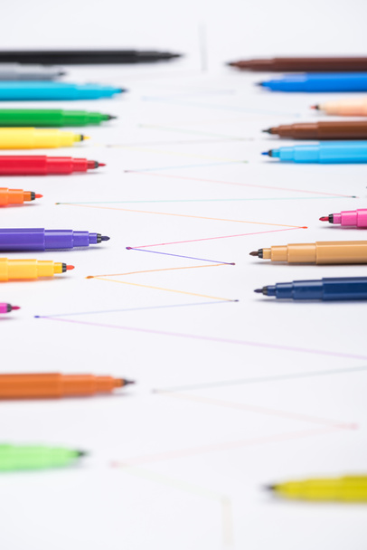 selective focus of multicolored felt-tip pens on white background with connected drawn lines, connection and communication concept - 写真・画像