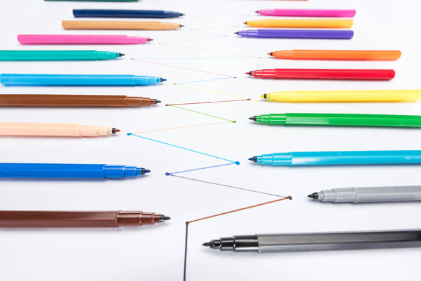 selective focus of felt-tip pens on white background with connected drawn lines, connection and communication concept - Photo, image
