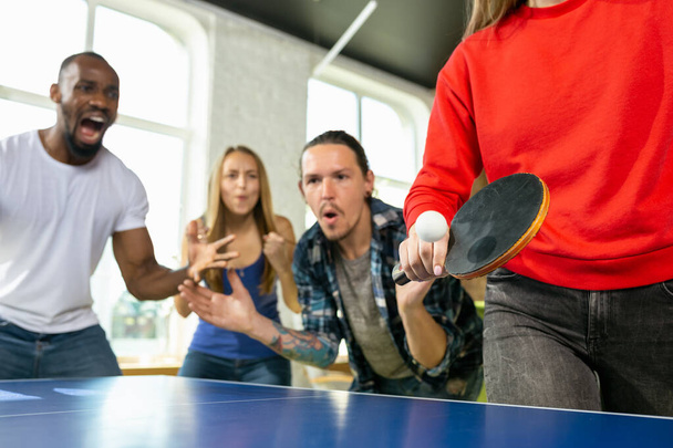 Young people playing table tennis in workplace, having fun - 写真・画像