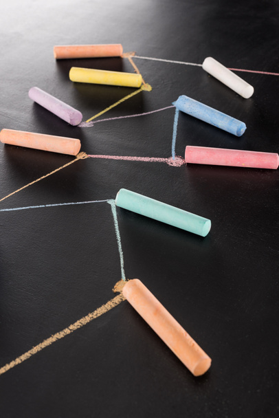 colorful chalk on black surface with connected drawn lines, connection and communication concept - Photo, Image