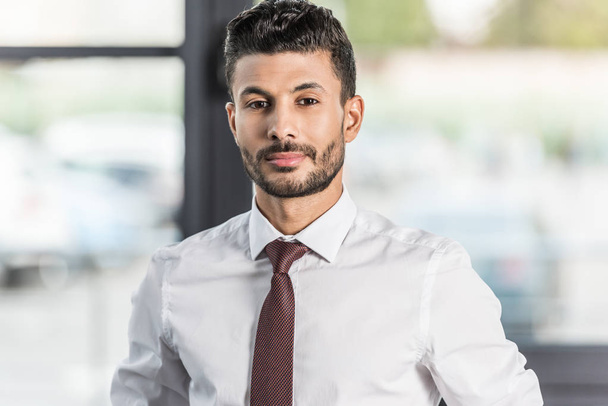 young, confident businessman in white shirt looking at camera - Photo, image