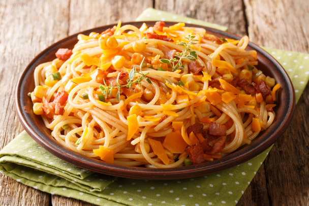 portion of spaghetti with fried bacon, corn and cheese close-up  - Photo, Image