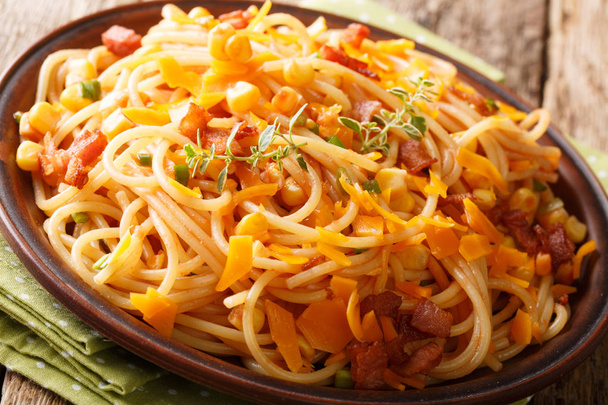 Hot Italian spaghetti with bacon, corn and Mimolette cheese clos - Photo, Image