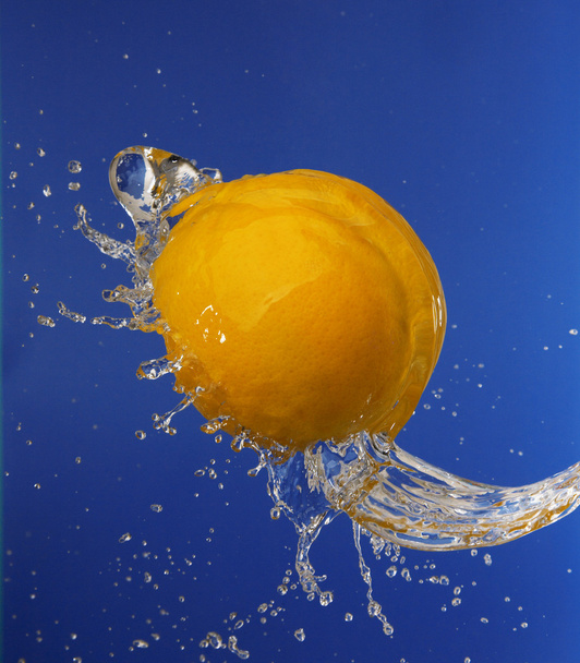 Splash in water with an orange - Photo, Image