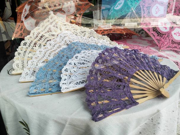 Multiple  handmade and  embroidered fan exposed for sale in a local store - Photo, Image
