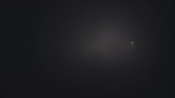 Silhouette of man in thick fog. Stock footage. Black silhouette of man with flashlight shining in thick grey smoke. Man with flashlight makes his way through darkness in smoke - Footage, Video