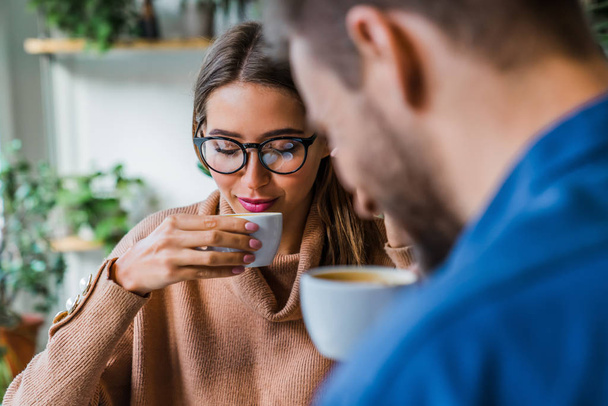 Young couple in casual having coffee together at the coffee shop - Photo, image