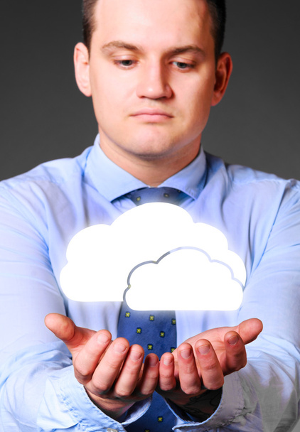 businessman is holding clouds - Foto, Imagem
