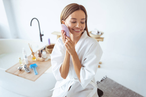 Positive delighted girl enjoying her home spa - Photo, image