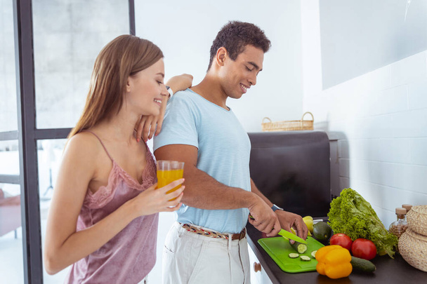 Positive delighted man preparing salad for breakfast - Photo, image