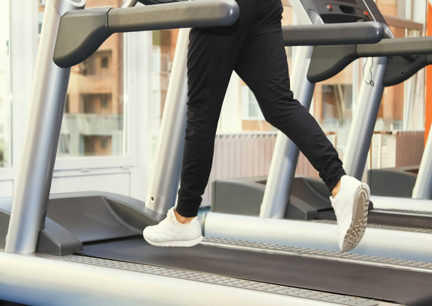People at the gym exercising. Run on a treadmill - Photo, Image