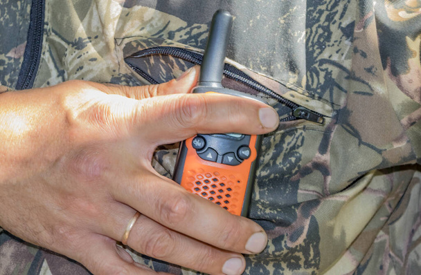 Portable radios in human hands and on clothing items - Photo, Image