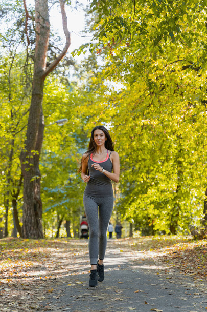 Pretty woman jogging in the park alone - Photo, Image