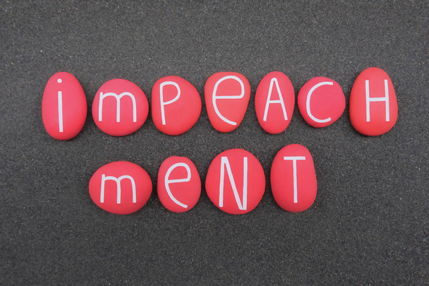 Impeachment text composed with red colored stone letters over black volcanic sand - Photo, Image