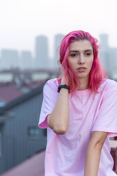 portret van een meisje met roze haar op het dak - Foto, afbeelding