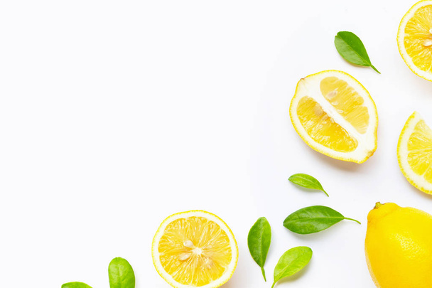 Fresh lemon with slices isolated on white. - Valokuva, kuva