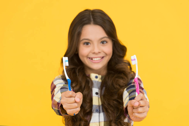 First rule of personal hygiene. Tooth brushes for dental hygiene. Toothbrushes in kids hands selecitive focus. Proper oral hygiene requires regular brushing. For fresh breath practice good hygiene - 写真・画像