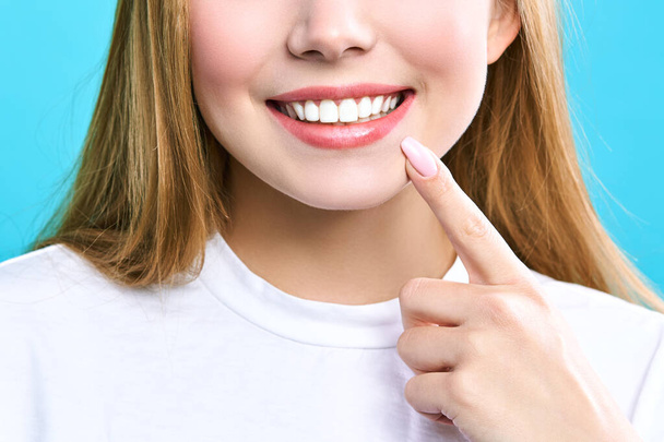 Perfect healthy teeth smile of a young woman. Teeth whitening. Dental clinic patient. Image symbolizes oral care dentistry, stomatology. - Foto, immagini