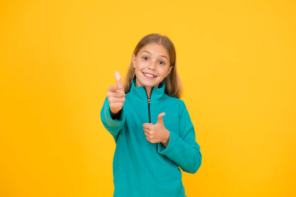 Good choice. Happy girl pointing gun hand gesture. Target and targeting. Small child smiling and pointing yellow background. Pointing gesture as nonverbal communication. Pointing and aiming - Foto, Bild