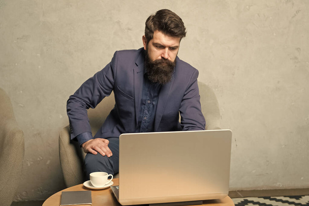 Computer networking business. Bearded man working at his computer in office. Businessman using computer for business. Professional computer repairman or tech worker - Φωτογραφία, εικόνα