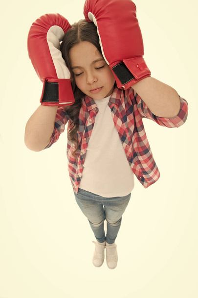 Headache concept. Keep calm and get rid of headache. Beat headache. Girl boxing gloves ready fight. Kid strong girl suffer pain. Child painful face embrace head with boxing gloves. Defence remedies - 写真・画像