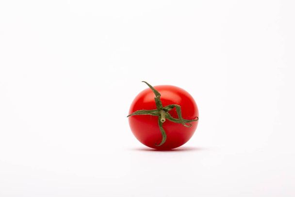 A closeup shot of a cherry tomato on a white background - perfect for a food blog - Fotografie, Obrázek