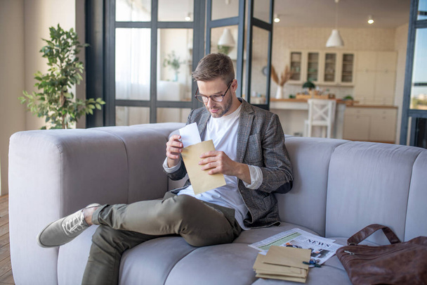 Businessman putting letter inside envelope before going to post - Photo, Image