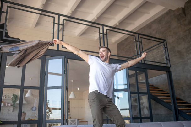Man dancing while feeling happy coming to his new flat - Fotó, kép