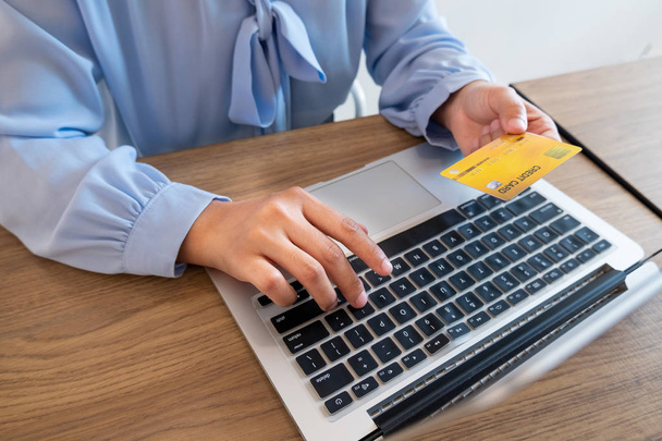 Οι γυναίκες των επιχειρήσεων χρησιμοποιούν πιστωτικές κάρτες και φορητούς υπολογιστές για online αγορές και πληρωμές στο διαδίκτυο - Φωτογραφία, εικόνα