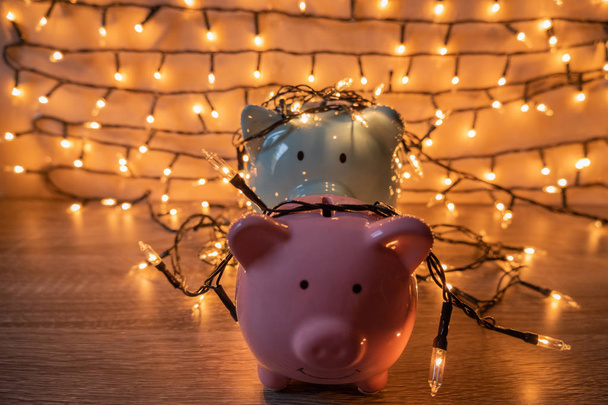 Pink and blue piggy bank with glittering lights, organize parties for successful activities to save money for retirement - Photo, Image