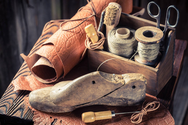 Closeup of shoemaker workshop with shoes and laces - Foto, Imagem