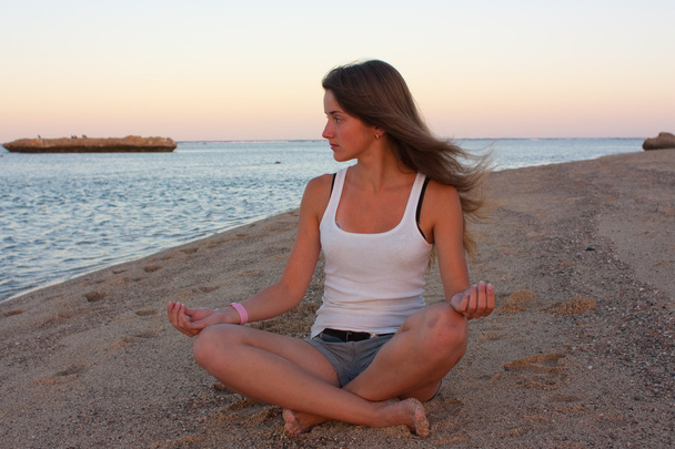 Girl doing yoga near sea - Zdjęcie, obraz