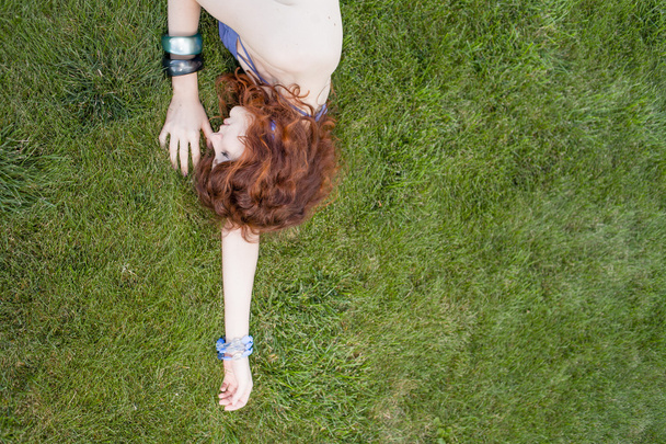 Pretty redhead lay on the grass - 写真・画像