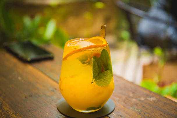 A closed up shot of a orange and mango mocktail served at a hipster cafe called Locahouz at Malacca, Malaysia. - Фото, зображення