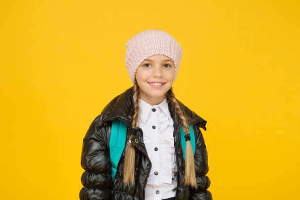 Future focused learning. Happy little schoolgirl smiling on yellow background. Small child in autumn fashion. Going towards brighter future. Future generation. Todays children are tomorrows future - Фото, изображение