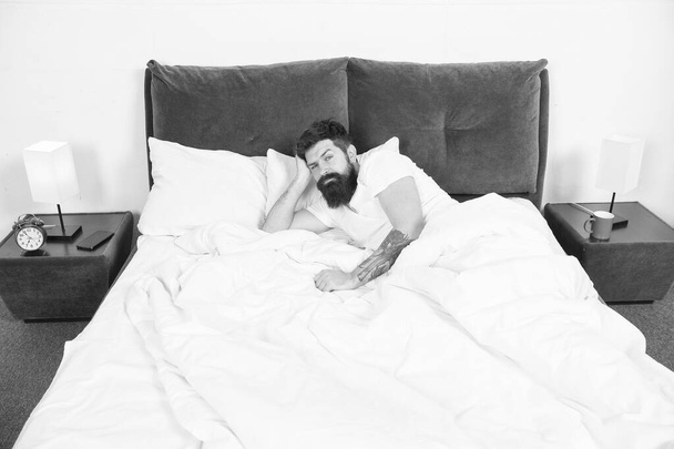 Insomnia. Sleep disorders concept. Man bearded hipster having problems with sleep. Guy lying in bed try to relax and fall asleep. Relaxation techniques. Violations of sleep and wakefulness - Foto, Imagen