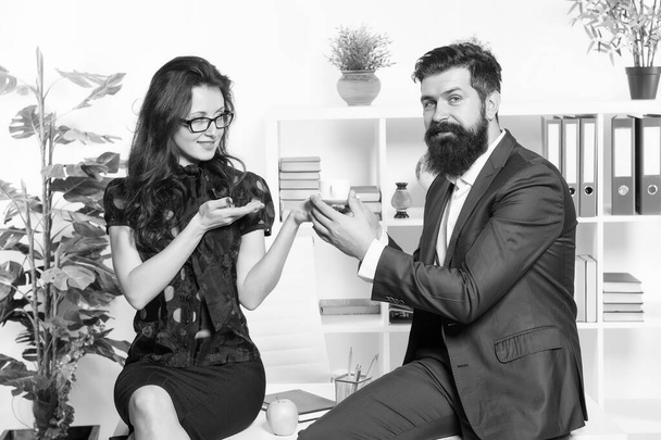 Coffee as ordered. Sensual woman giving coffee cup to bearded man in office. Sexy secretary and boss drinking coffee in the morning. Company empolyees enjoying coffee break together - Φωτογραφία, εικόνα