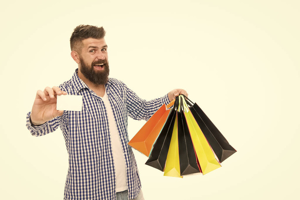 Discount is applied here. Bearded man smiling with discount card and paperbags isolated on white. Happy hipster shopping with price discount. Going to discount store, copy space - Фото, зображення