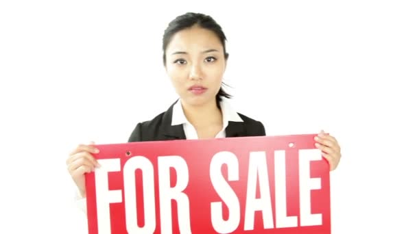 Businesswoman with sign "For sale" - Materiał filmowy, wideo