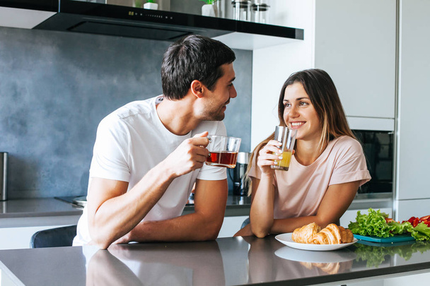 Photo of young couple starting the day together with coffee in the kitchen - Fotoğraf, Görsel