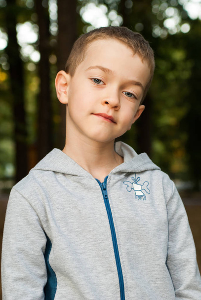 portrait of a boy in sportswear in a park - Photo, Image