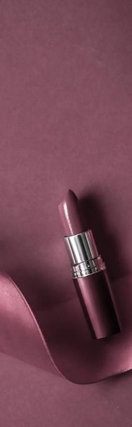 Luxury lipstick and silk ribbon on purple holiday background, ma - Fotoğraf, Görsel