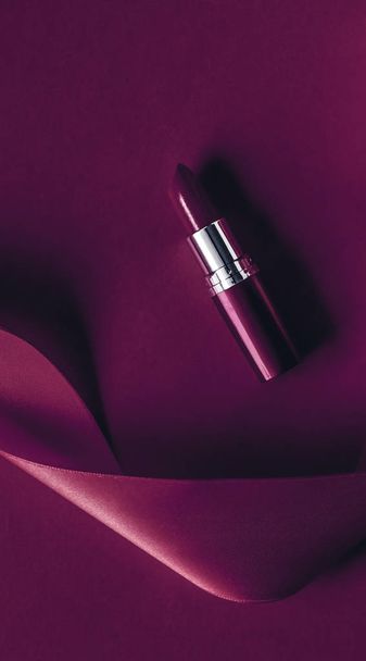 Luxury lipstick and silk ribbon on plum holiday background, make - Foto, immagini