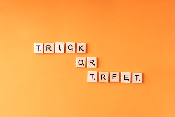 Wooden letters with text trick or treet on orange background. Halloween - Фото, изображение