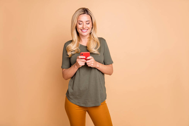 Photo of cheerful positive cute nice toothy beaming girlfriend standing in green confidently chatting wearing pants trousers yellow isolated pastel color background - Valokuva, kuva