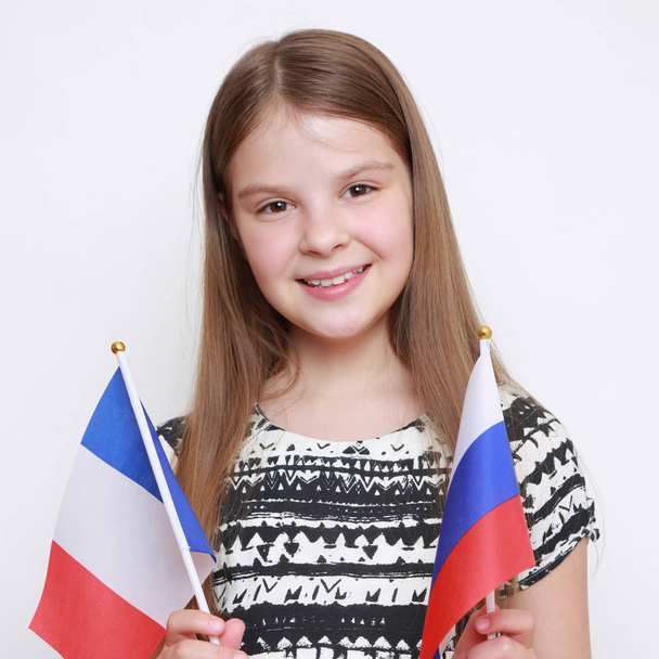Caucasian girl holding flags of Russian Federation and France - Φωτογραφία, εικόνα
